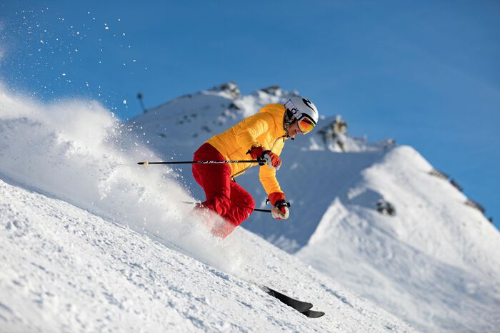 Alpine skiier going downhill. 