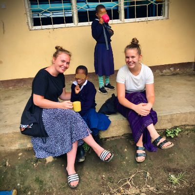 Picture of Ane and Emilie together with children from PTC.