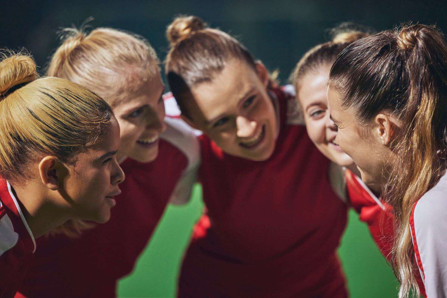 Women, football and team huddle on field at soccer. 